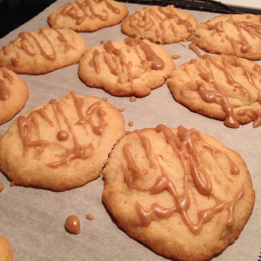 Maple sugar shortbread cookies with maple butter drizzled on the cookie